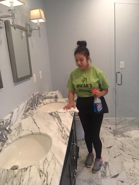 Woman cleaning marble sink